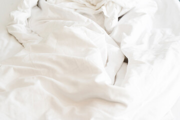 after waking up in the​ morning. The crinkle blanket on the bed in the hotel with the sun​light​ on​ the​ blanket