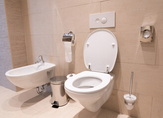 modern toilet with toilet, bidet and toiletries