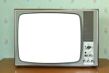 Old vintage white screen TV in a room with vintage wallpaper. Interior in the style of the 1960s.