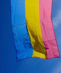  pansexual flag fluttering in the wind on a sunny day.
