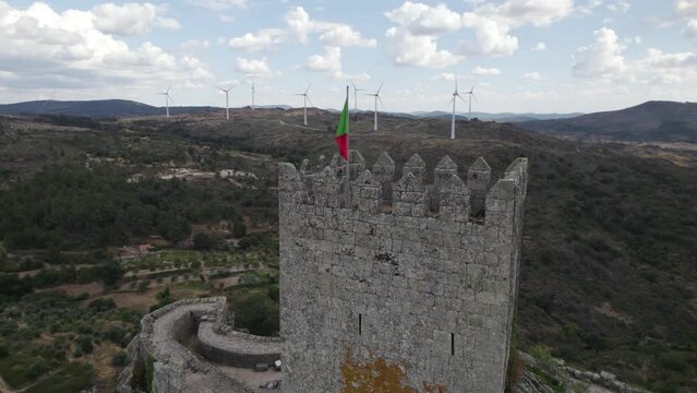 Main keep with Portuguese flag at Castle of Sortelha; aerial orbit