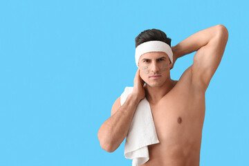 Handsome man with clay mask on blue background