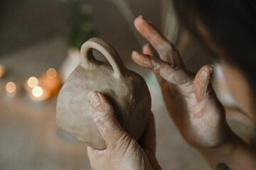 Female ceramist hands sculpt clay dishes