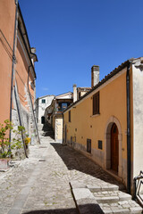 Fototapeta na wymiar A narrow street between the old houses of Morcone, a village in the province of Benevento, Italy.