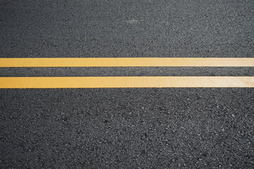 Fototapeta premium Blurred image of yellow traffic marking work on paved road
