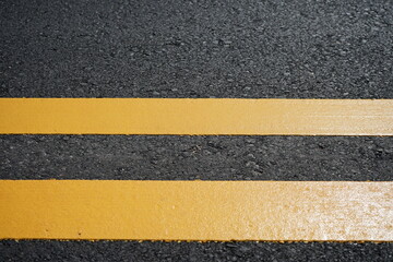 Fototapeta premium Blurred image of yellow traffic marking work on paved road
