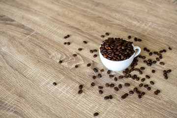 Fototapeta na wymiar Coffee background in cup on wooden table with flat space for text.