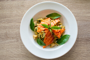 Plate of delicious pasta with mushrooms on table