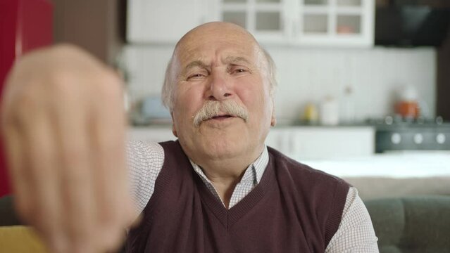 Portrait of human hand showing to camera. Hand kissing.The old man who extends her hand to kiss her visitors during the feast (Ramadan or Şeker Bayram). People who adhere to Muslim traditions.