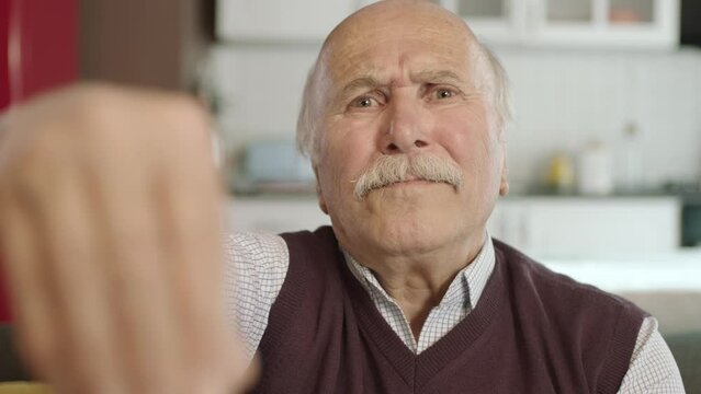 Portrait of human hand showing to camera. Hand kissing.The old man who extends her hand to kiss her visitors during the feast (Ramadan or Şeker Bayram). People who adhere to Muslim traditions.