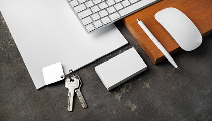 Blank stationery, keys and gadgets. Real estate agency concept.