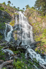 Vertical shot of waterfall with vegetation on the sides in southern Chile