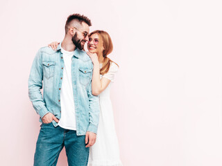Sexy smiling beautiful woman and her handsome boyfriend. Happy cheerful family having tender moments near blue wall in studio.Pure cheerful models hugging.Embracing each other. Cheerful and happy