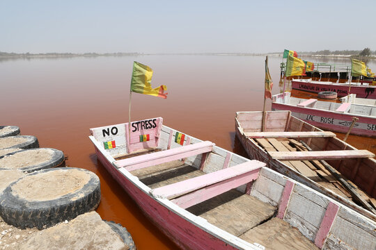 Lake Retba, Lac Rose in Senegal, Africa. Senegalese landscape, scenery. African landmark. Nature, lake Retba, Lac Rose in Senegal. Pink boat, ship and Lake Retba