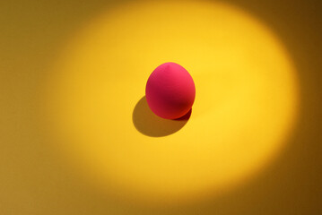 pink sponge for the face on a yellow background has a place for the inscription