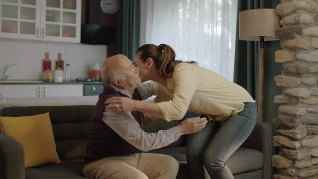Woman kissing her father's hands, celebrating eid or father's day.Young woman kissing her old father's hands during the feast (Ramadan or Şeker Bayram). People following Muslim traditions.