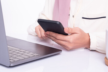 Close up, Woman with a finger on the screen using a mobile phone in the office.