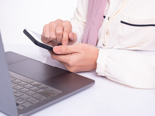Cropped image. Woman with a finger on the screen using a mobile phone.