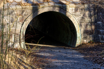 A short walking tunnel exit under a bridge
