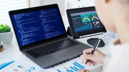 Back rear view of young asian woman, freelance data scientist work remotely at home coding...