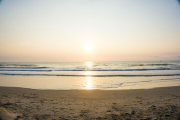 Naklejka na ściany i meble Wave beach sunset with light nature vacation background