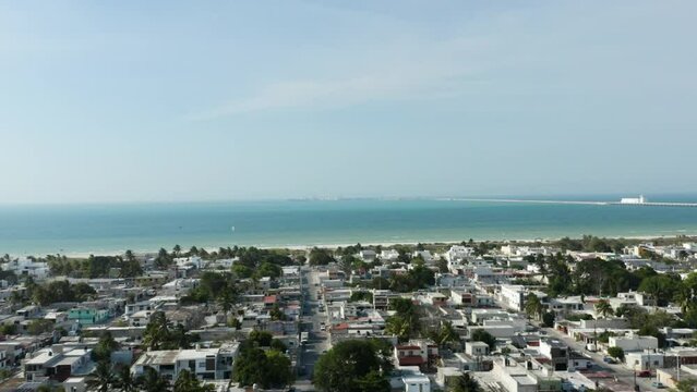 Tilt up aerial view over Puerto Progreso city in Yucatan peninsula, Mexico. Turquoise ocean water in the background