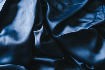 luxurious navy blue silk or satin fabric close-up for bedding or clothes