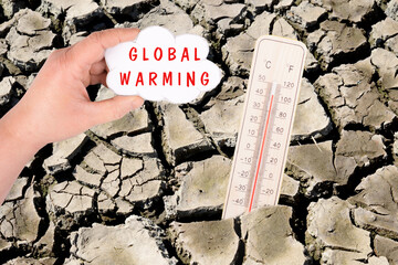 Dry earth with a thermometer, global warming and climate change concept, environmental discussion,...