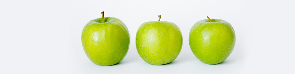 row of green and ripe apples on white, banner.
