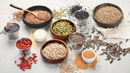 Variety of edible seeds on light background.