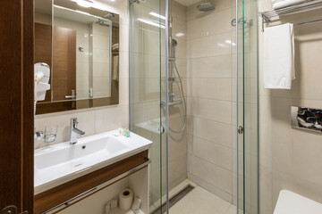 Interior of a hotel bathroom with glass shower cabin
