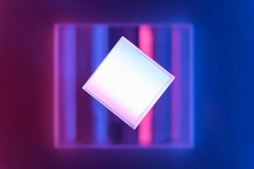 Neon background with geometric shapes. Luminous glass objects with multi-colored lighting, soft selective focus, copy space.