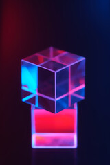 Optical glass objects with multi-colored lighting. Neon background with geometric shapes, soft selective focus.