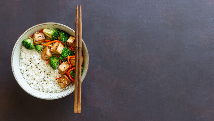 Rice with tofu, broccoli, carrots and sesame. Bowl. Healthy eating. Vegetarian food.