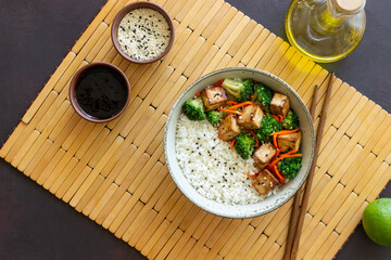 Rice with tofu, broccoli, carrots and sesame. Bowl. Healthy eating. Vegetarian food.