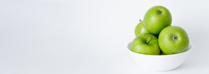 bowl with green and ripe apples on white, banner.