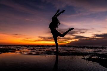 silhouette of person jumping on the beach