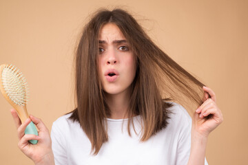 Hair loss problem treatment. Portrait of woman with a comb and problem hair.