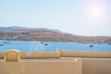 Mediterranean bay with boats and sandy beaches under the bright sun.