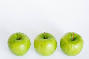high angle view of green and ripe apples on white.