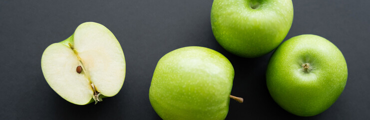 top view of juicy and green apples on black, banner.