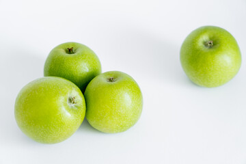 ripe and fresh green apples on white.