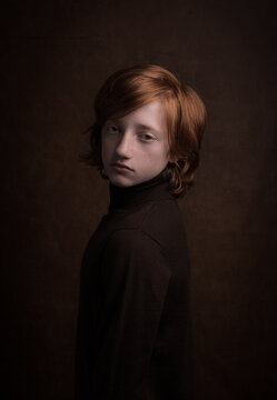Classic painterly renaissance studio portrait of a ginger boy in dark Rembrandt style