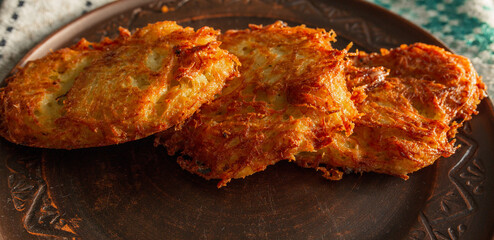 Fried potato pancakes on a clay brown plate. food, potato pancakes, dish