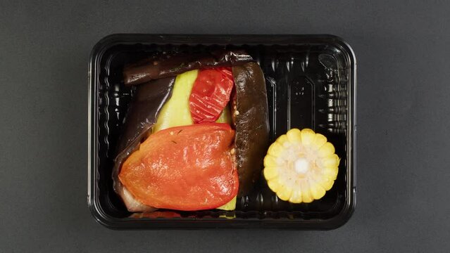 Packaging take away meals into paper bag top view, Food delivery in disposable containers, balanced nutrition. Fresh cooked portions in lunch boxes, vegetarian dishes. Healthy eating. Catering service