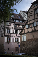 historical wooden half-timbered architecture of the alsace town on the river bank