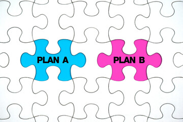 Fototapeta premium Missing puzzle pieces with the words plan a versus plan b. business strategy ideas and planning. Backup plan. 