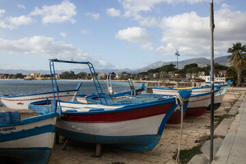 Naklejka na ściany i meble evocative image of fishing boats moored in the harbor in a small fishing village in Sicily, Italy 