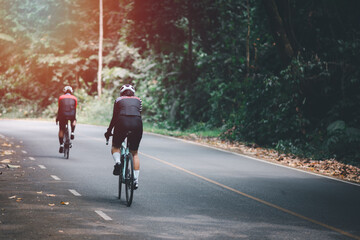 Obraz premium Women on road bikes exercise to stay healthy.