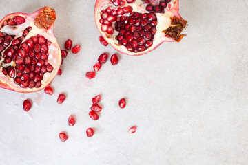 Pomegranate broken open with pips on a grunge surface with copy space